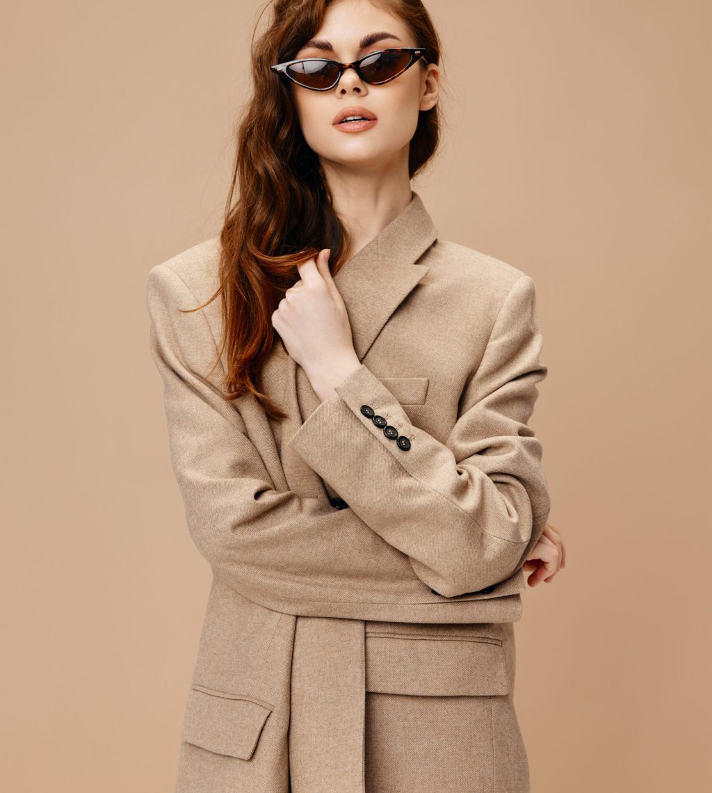 Portrait Of Woman Standing Against Beige Background Portrait Of Woman Standing Against Beige Background